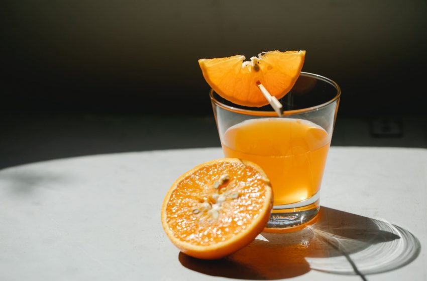 orange pieces with glass of juice